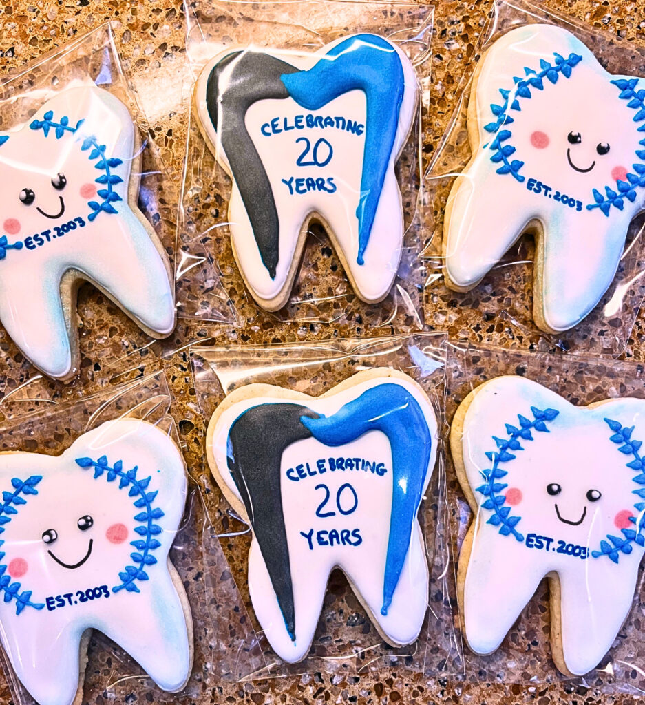 Custom decorated and wrapped dental office anniversary sugar cookies.