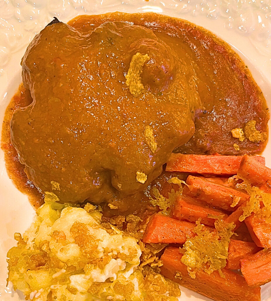 Salisbury steak, Oven Sauteed Carrots, and Country Scalloped Potatoes on a white plate