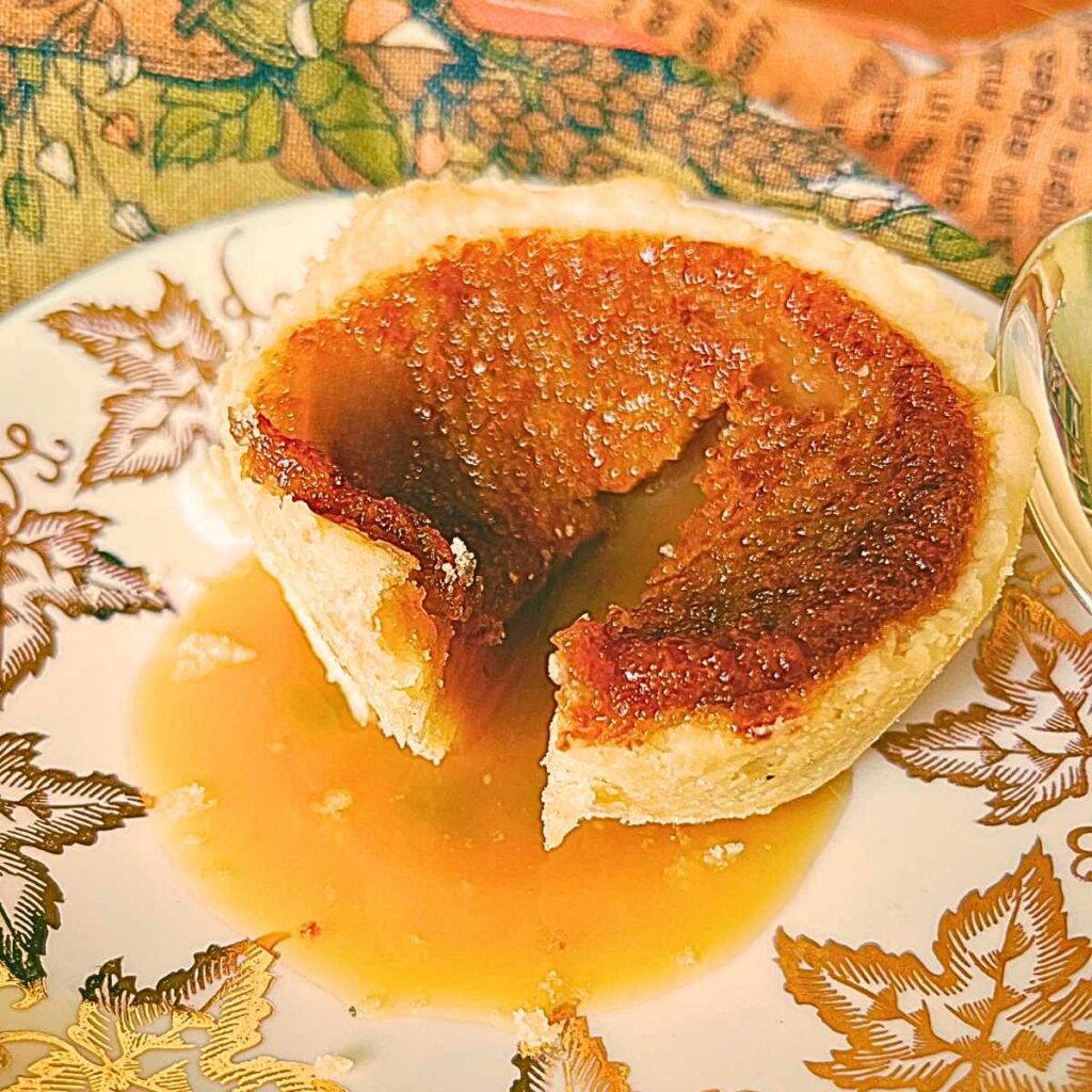 Butter tart on a gold maple leaf plate.