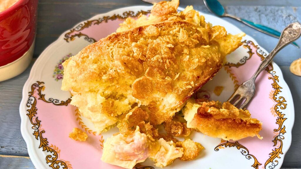 A pink and white plate with a breakfast strata.