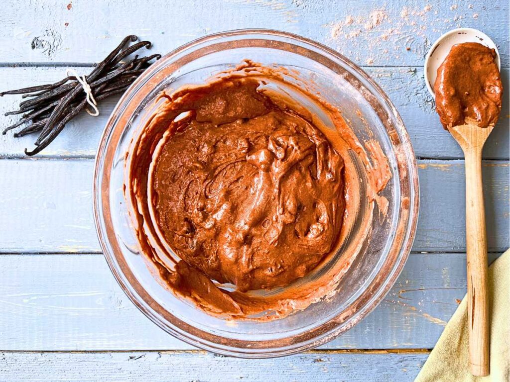 A chocolate cake batter in a glass bowl.