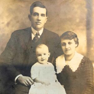 An antique picture of two parents and a child.
