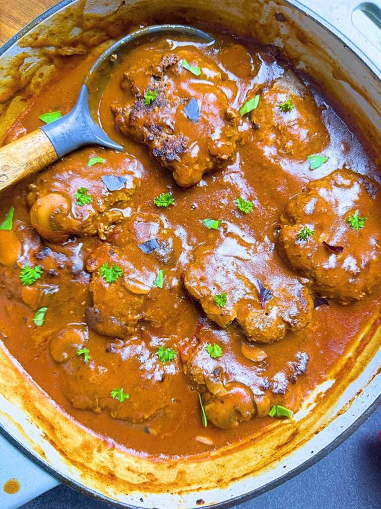 Cooked salisbury steaks in mushroom gravy.