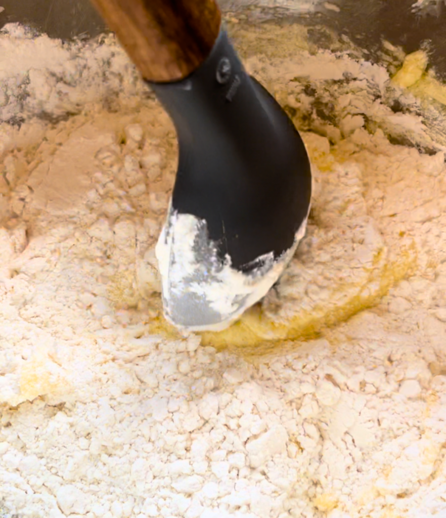 A large spoon stiring muffin batter