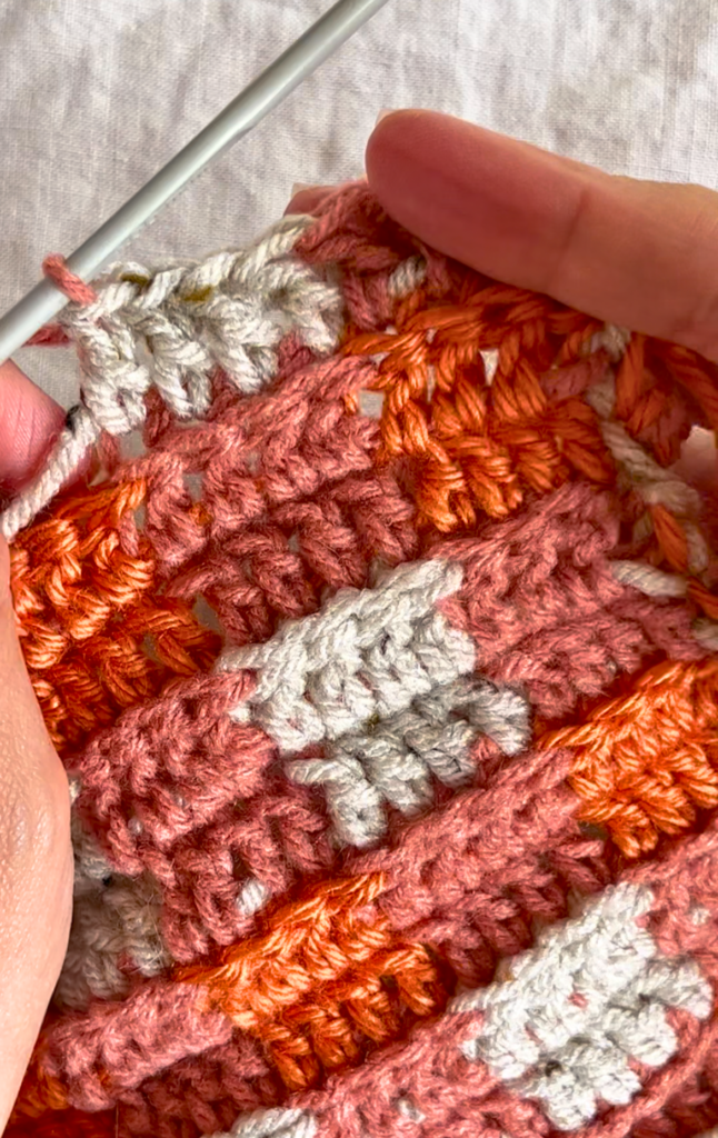 Double crochet with cream, pumpkin, and baked clay yarn