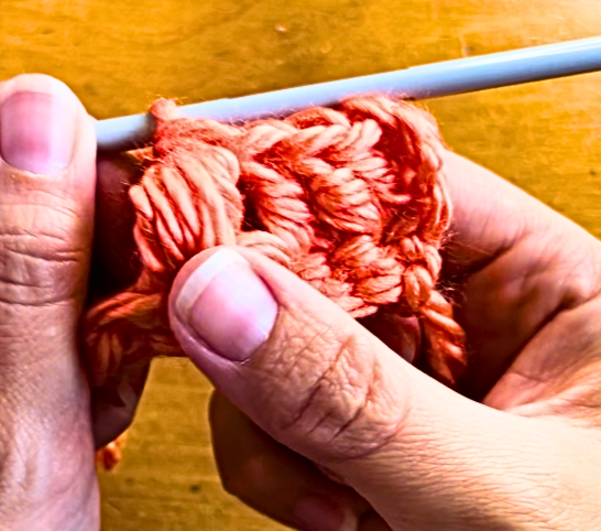 orange yarn on a crochet hook