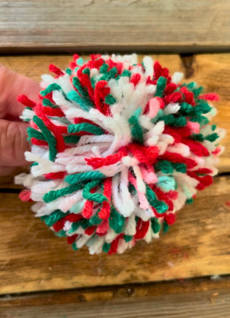Finished red, white, and green pompom