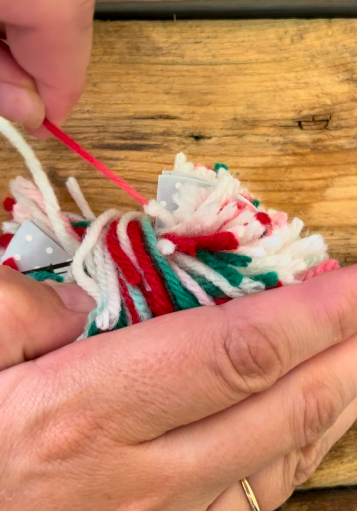 Tying red white, and green yarn 
