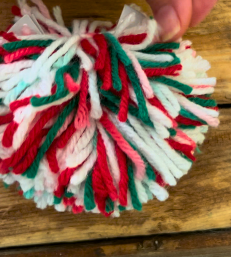 Tying red, white, and green yarn