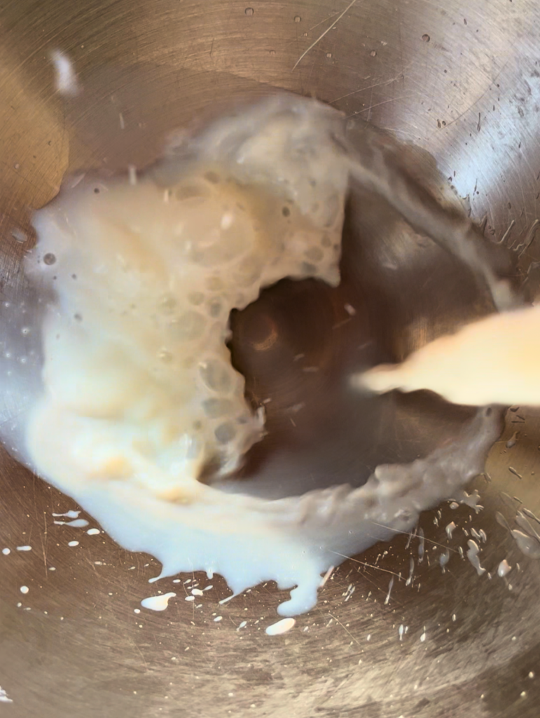 Adding milk to a silver bowl