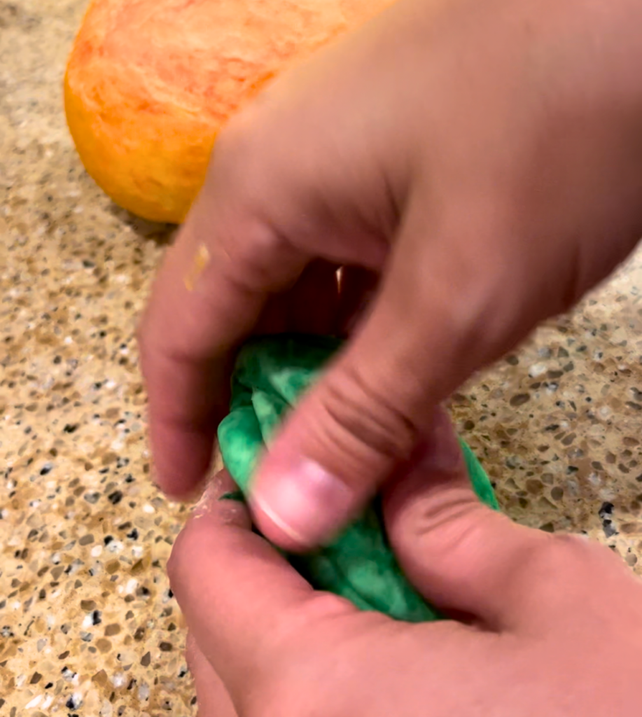 Woman kneading green dough