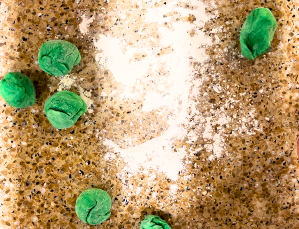 pieces of green dough on a counter top