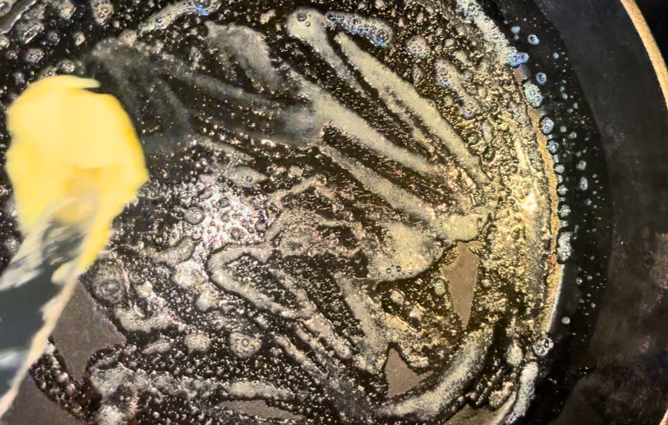 Butter melting on a cast iron skillet