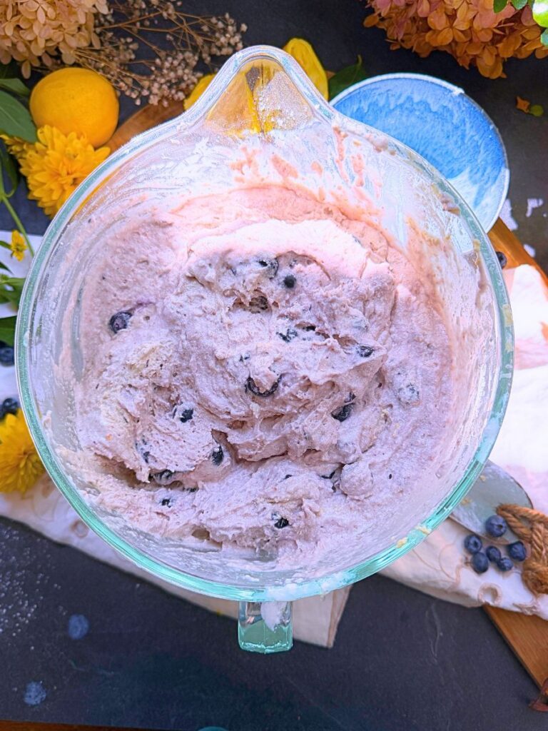 Lemon blueberrt muffin batter in a large glass bowl.