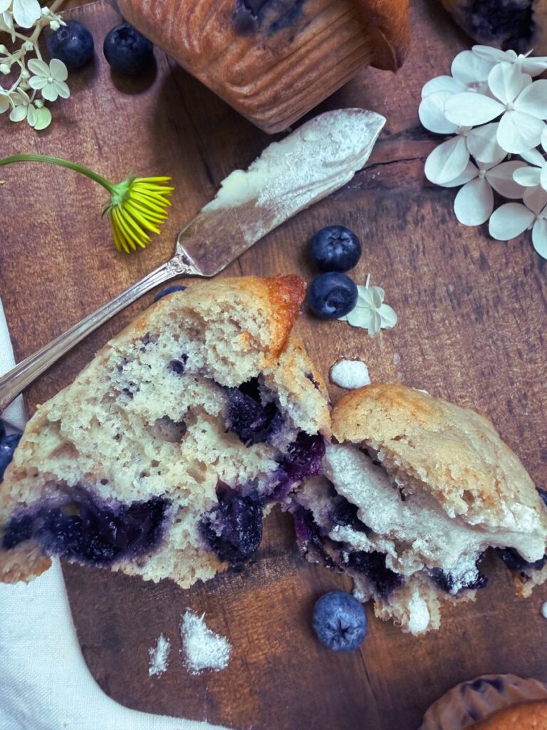 A lemon blueberry muffin split in half.