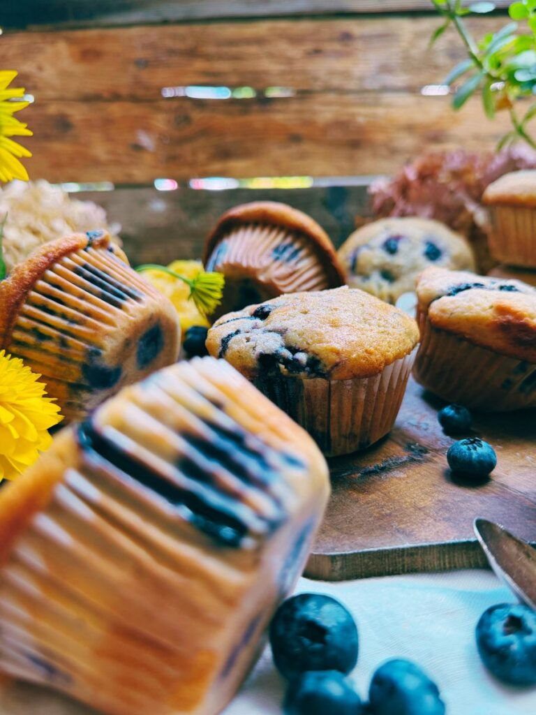 A side view of a collection of blueberry muffins.