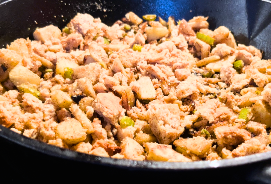Adding bread crumbs to a skillet of apples and celery with spices.