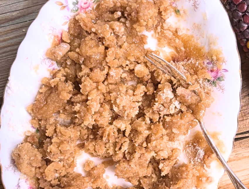A mixture of streusel on a white plate with pink flowers