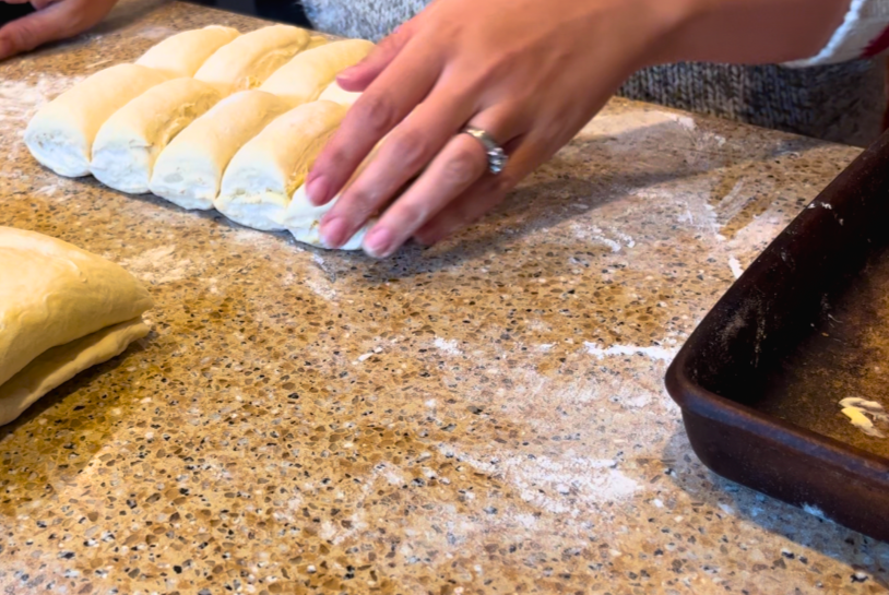 A woman cutting dough into portions