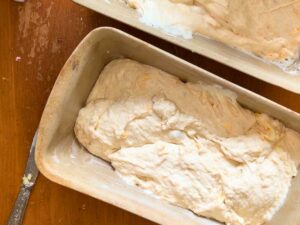 Bread dough in two loaf pans.