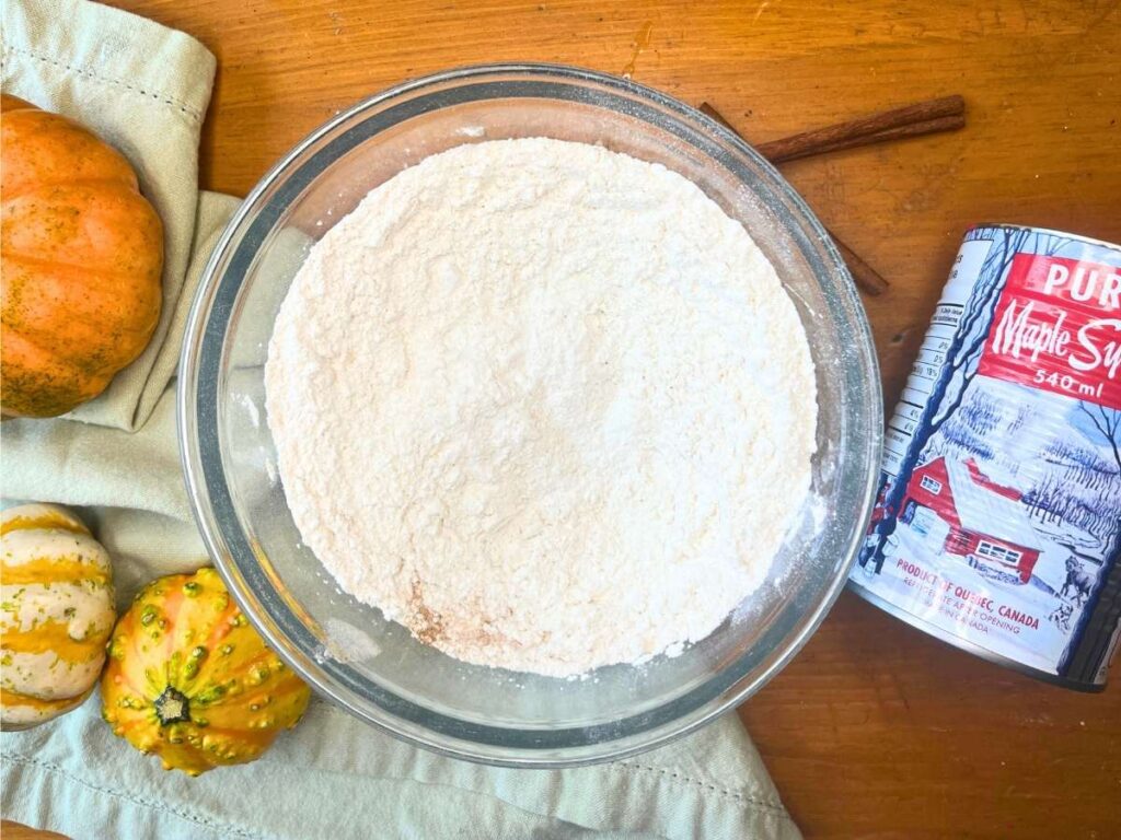 A glass bowl full of a flour mixture.