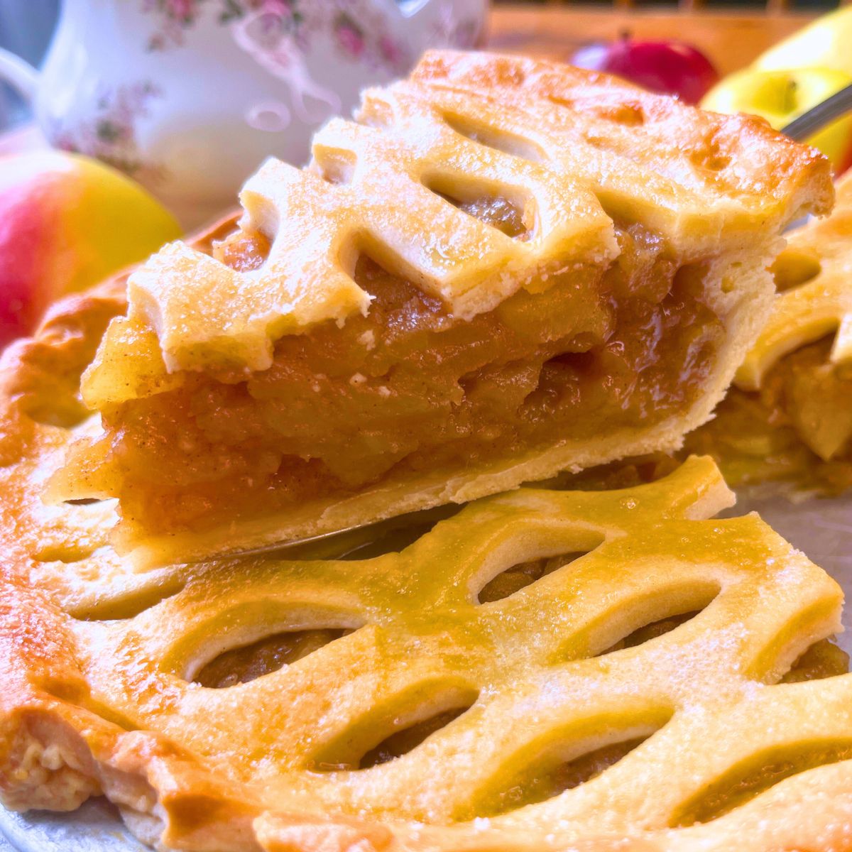 A side view of a slice of apple pie showing the interior filling.