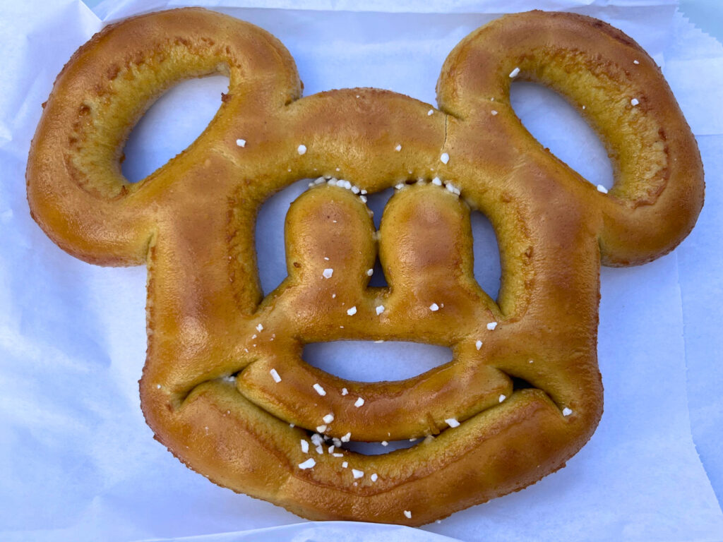 A mickey shaped pretzel on a piece of parchement