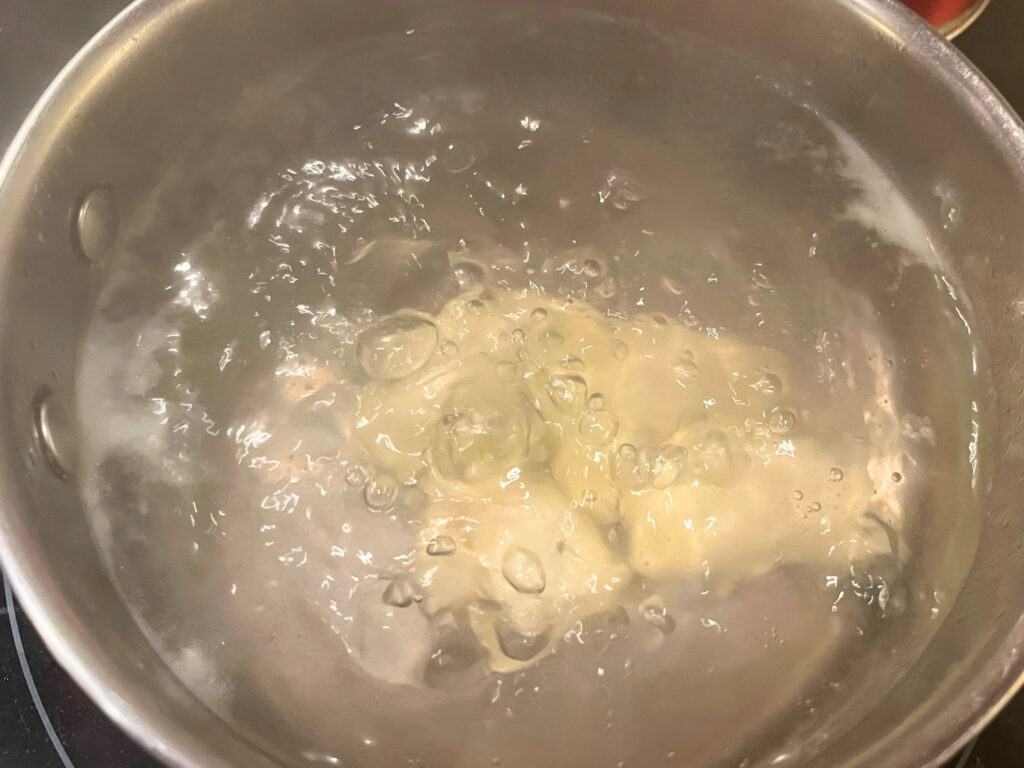 Pierogies boiling in a pot of water