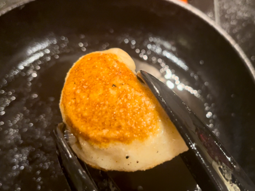 A close op of a cooked and fried pierogi.