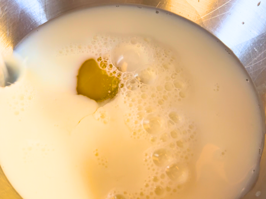 Egg and milk mixture in a metal bowl