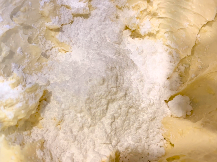 Icing sugar on top of whipped butter and cream cheese