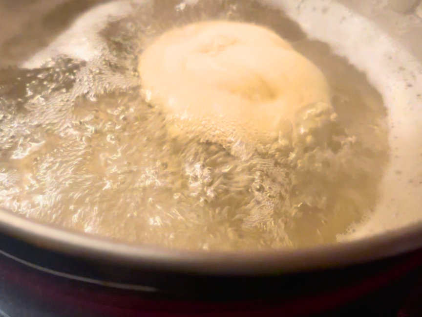 Pretzel boiling in a large pot