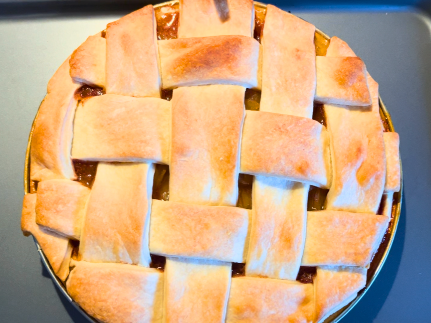 A baked apple pie on a metal cookie sheet