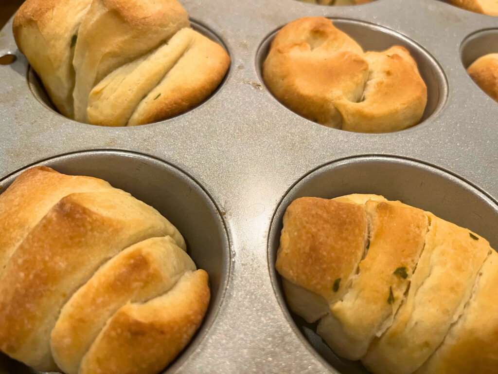 Baked garlic pull apart bread rolls in a muffin tin