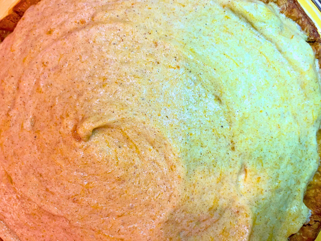 A smoothed surface of a pumpkin chiffon pie.