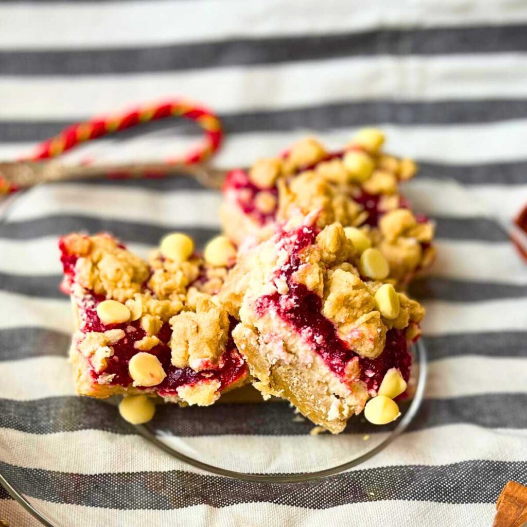 Three cheesecake bars on a glass plate.