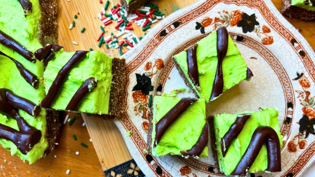 Mint chocolate squares on a brown floral plate.