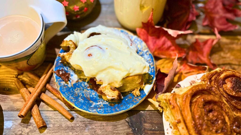 A cinnamon roll on a blue plate.