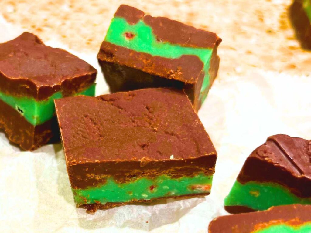 A close up look at some bite-sized layered mint chocolate candies.