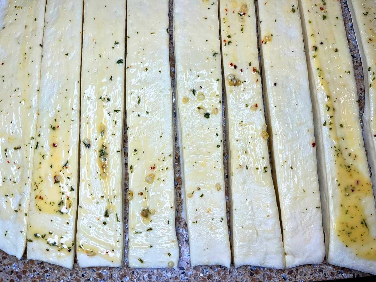 Strips of dough brushed with garlic butter.