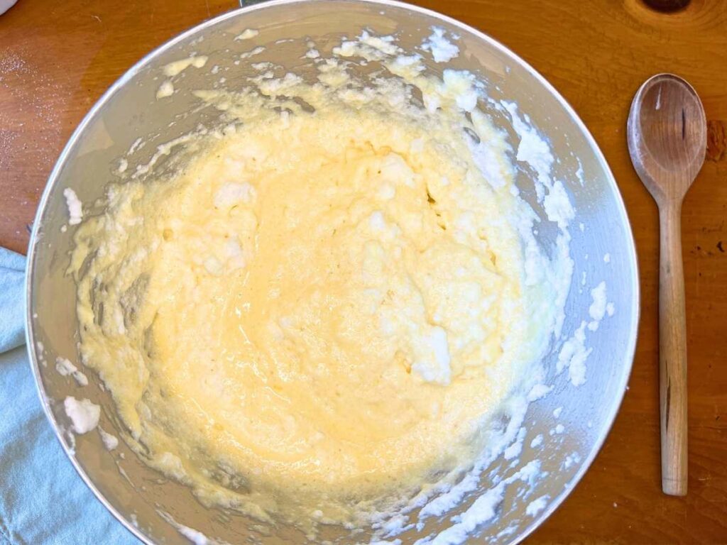 a metal bowl with cake batter inside.