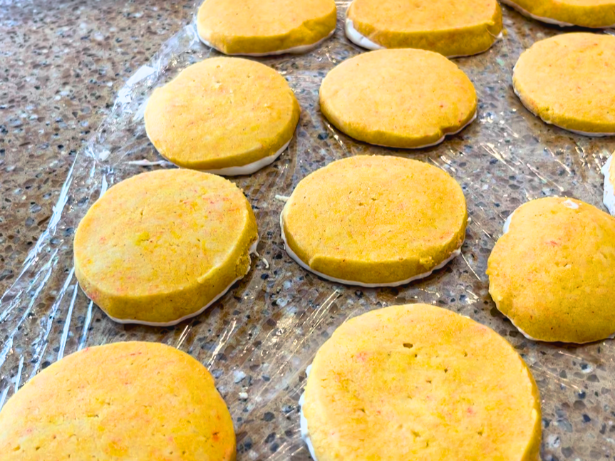 Orange cardamom shortbread cookies sitting on a counter top.