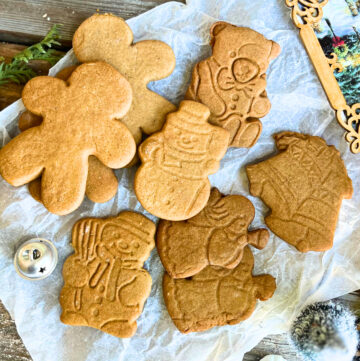 Gingerbread cut-out cookies on a piece of parchment paper.