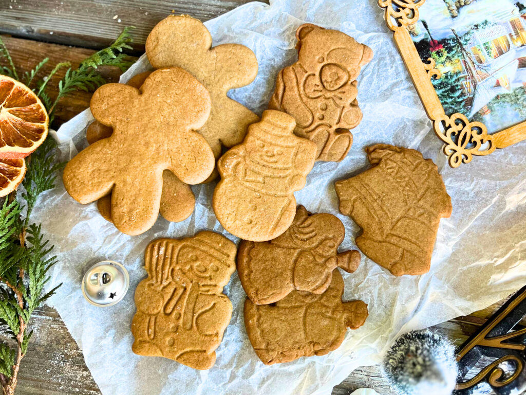 Gingerbread cookie cut-outs on a piece of parchment paper