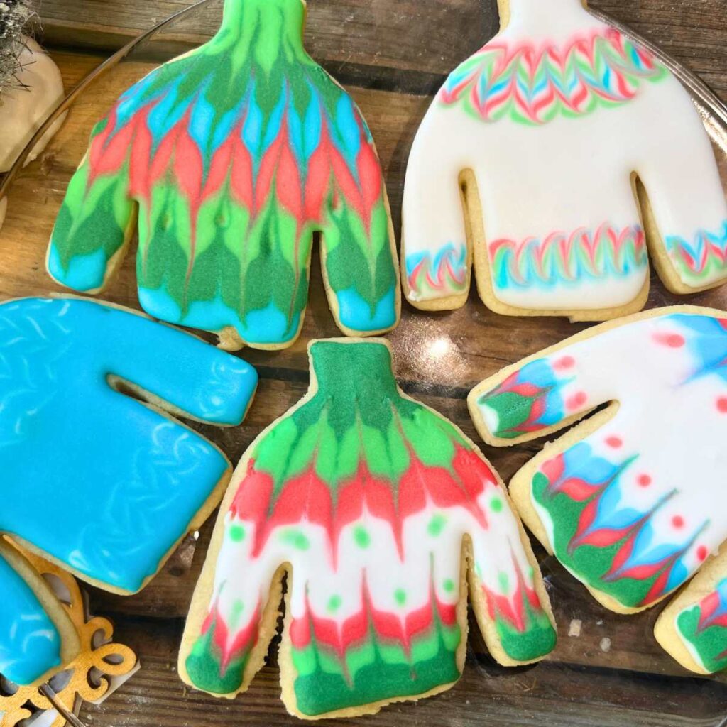 Cookies decorated as winter sweaters.