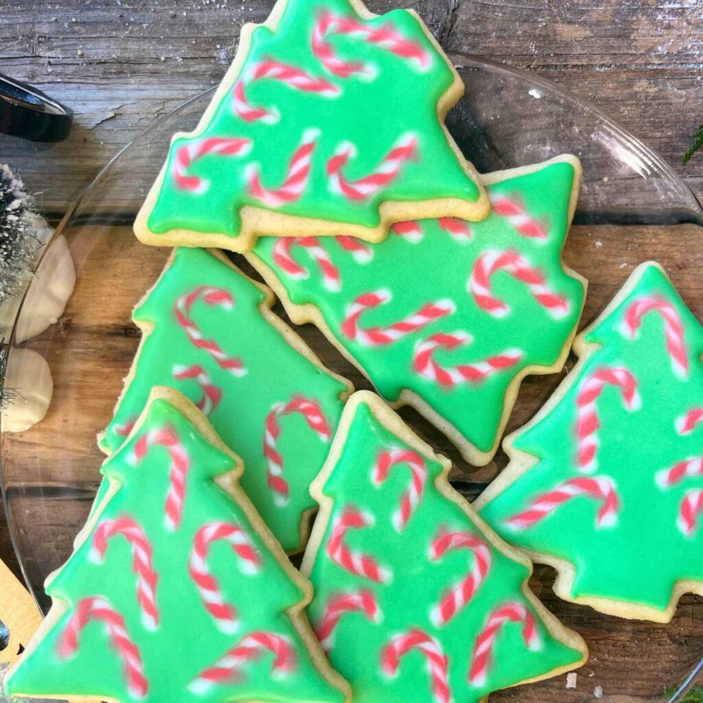 Christmas tree cookies decorated with candy cane icing.