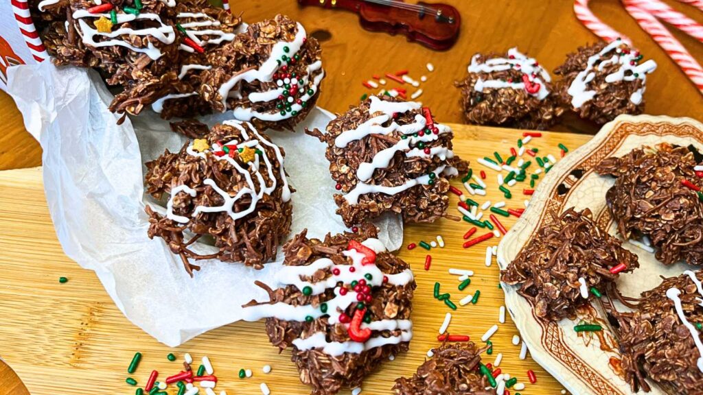 A group of chocolate haystacks decorated with  icing and festive sprinkles.