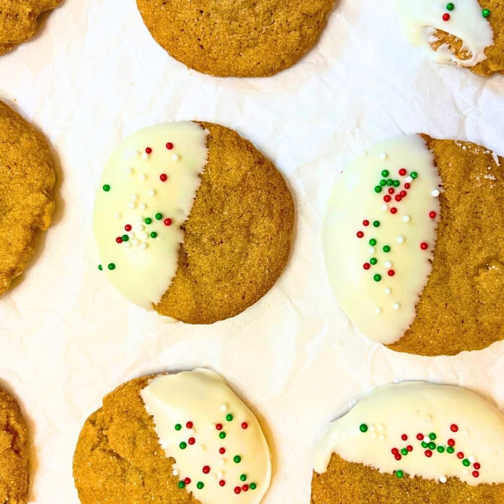 Decorated gingerbread cookies on a piece of parchment paper.