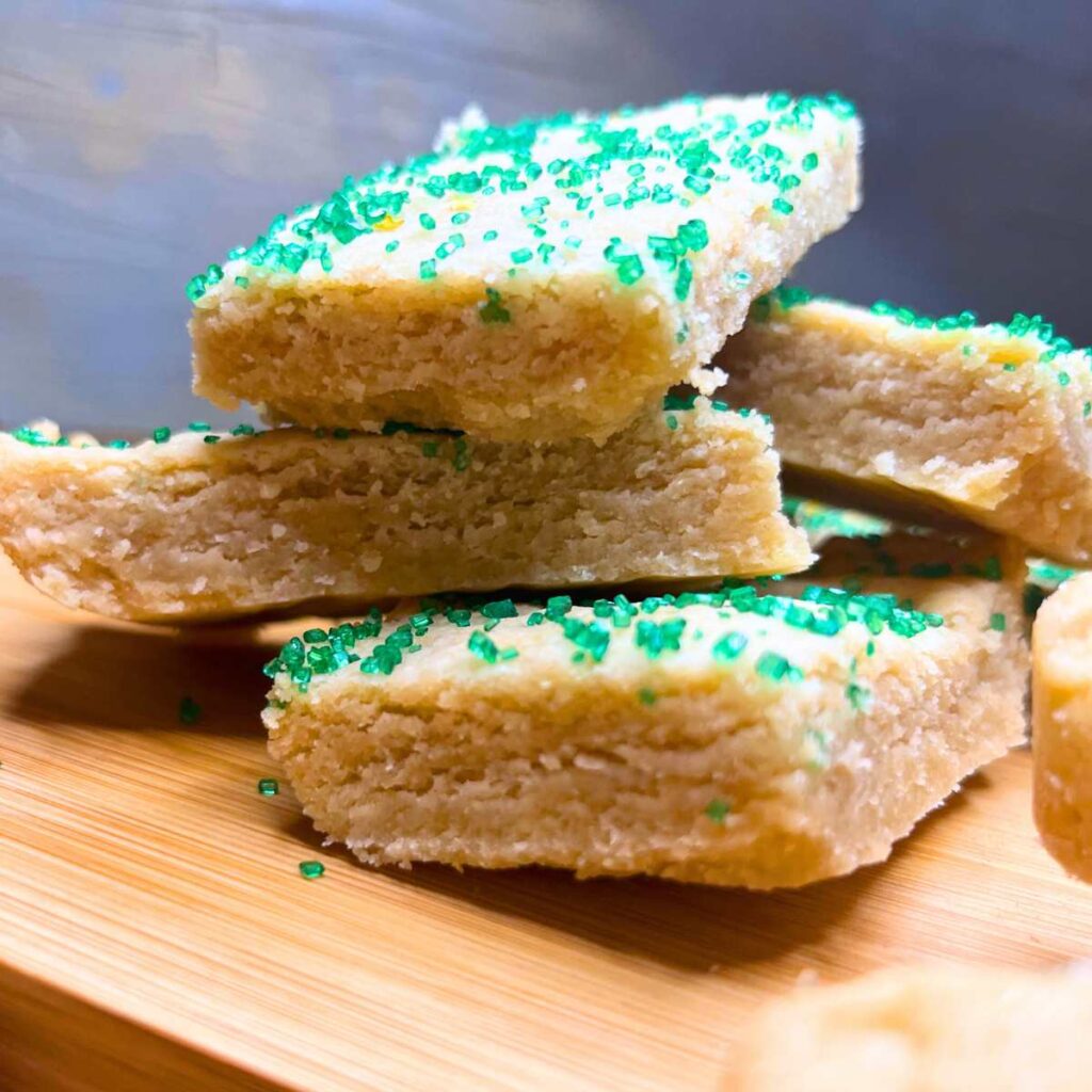 A sideview of a stack of shortbread cookies.