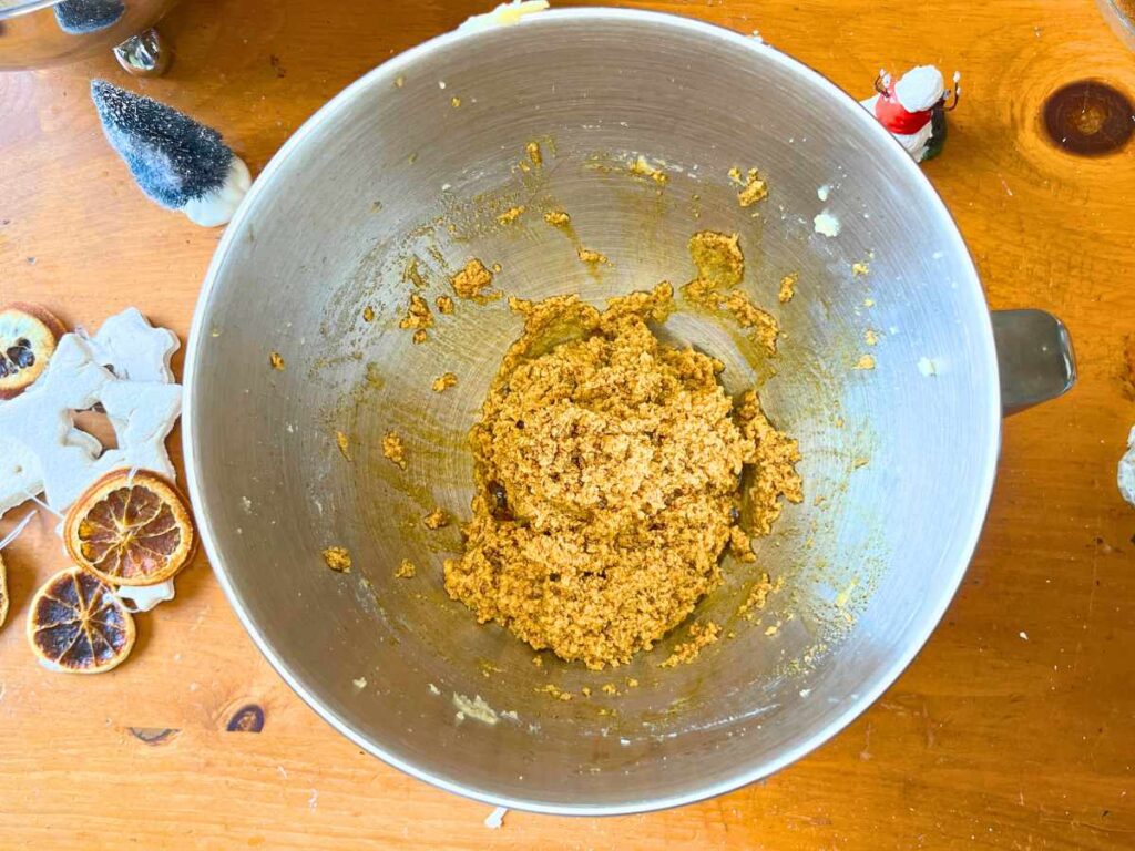 A metal bowl with a gingerbread mixture inside.